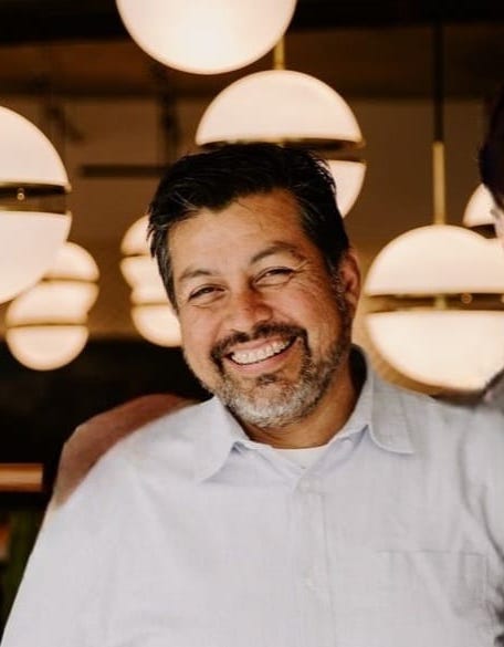 Arturo Rodriguez, founder of Art's General Construction, smiling in a professional setting